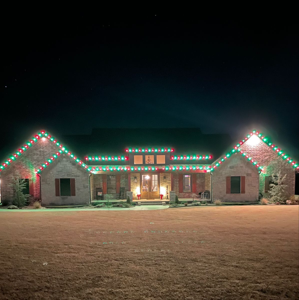 Landscape lighting on a home and garden beds at night